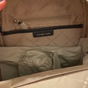 Michael Kors backpack, brand new. Tags and metal zippers wrapped